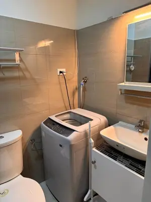 a bathroom with a toilet and a sink at Iris Suites in Manila