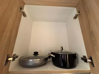 a large pot sitting on a shelf in a kitchen at Iris Suites in Manila