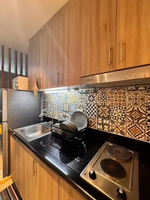 a kitchen with a stove and a counter top at Iris Suites in Manila