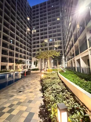 a large building with a walkway in front of it at Iris Suites in Manila