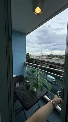 a balcony with a table and a view of a freeway at Jules Cozy StayCay II in Manila