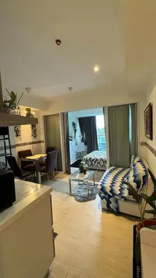 a living room with a couch and a table at Jules Cozy StayCay II in Manila