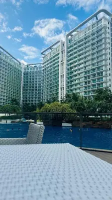 a large building with a river in front of it at Jules Cozy StayCay II in Manila