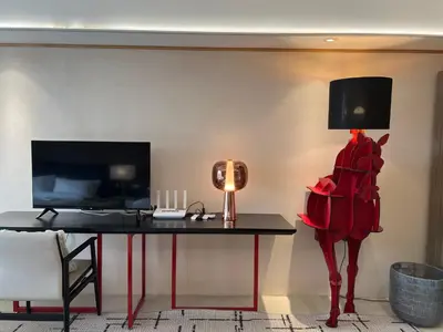 a room with a table with a lamp and a bed at Luxurious Style Apartment cross to Okada and near City of Dreams, Solaire, MOA, and Airport in Manila