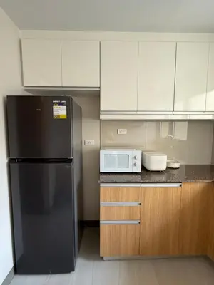 a kitchen with a black refrigerator and a microwave at Luxurious Style Apartment cross to Okada and near City of Dreams, Solaire, MOA, and Airport in Manila