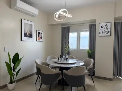 a dining room with a table and chairs at Luxurious Style Apartment cross to Okada and near City of Dreams, Solaire, MOA, and Airport in Manila