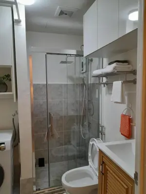a bathroom with a shower with a toilet and a sink at Cali Suite - Nuvali in Pitland