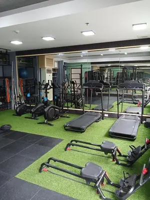 a gym with rows of exercise equipment on the floor at Cali Suite - Nuvali in Pitland