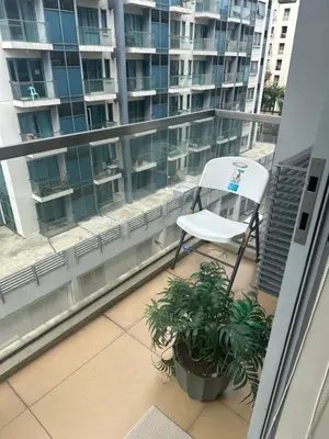 a white chair sitting on top of a balcony at One Palm Tree by Melba STUDIO TYPE in Manila