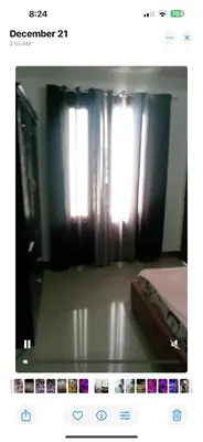 a picture of a room with a window with curtains at Fiona Apartment in Manila