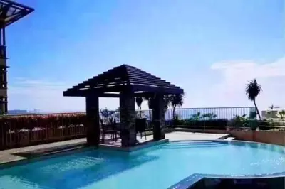 a swimming pool with a gazebo on top of it at Cozy Studio typeunit in Manila