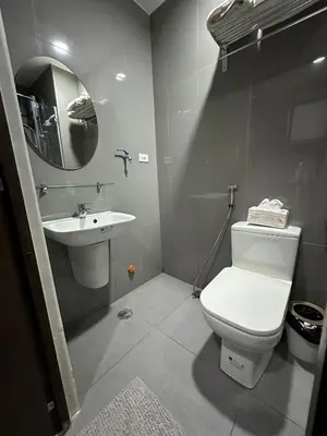 a bathroom with a white toilet and a sink at 2 Bed Suite at Air Residences Condo, Ayala Ave Makati in Manila