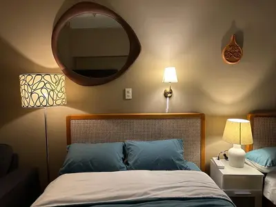 a bedroom with a bed with a large mirror on the wall at 2 Bed Suite at Air Residences Condo, Ayala Ave Makati in Manila