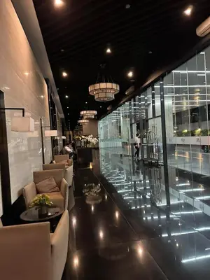 a lobby with couches and a glass floor at 2 Bed Suite at Air Residences Condo, Ayala Ave Makati in Manila