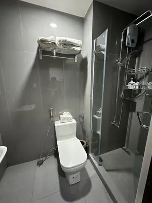 a bathroom with a toilet and a shower at 2 Bed Suite at Air Residences Condo, Ayala Ave Makati in Manila
