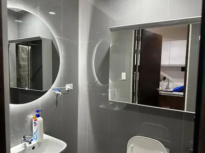 a bathroom with a sink and a mirror at A King-size bed at Air Residences Condo, Ayala Ave, Makati in Manila