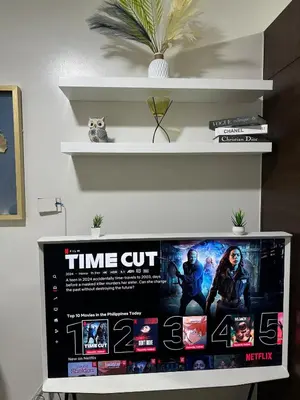 a tv sitting on top of a shelf at A King-size bed at Air Residences Condo, Ayala Ave, Makati in Manila