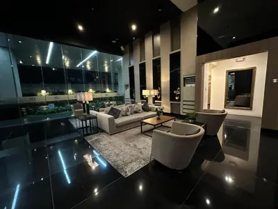 a living room with a couch and a table and chairs at Air Residences Apartment, Ayala Avenue Makati in Manila