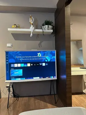 a television sitting on a stand in a room at Air Residences Apartment, Ayala Avenue Makati in Manila