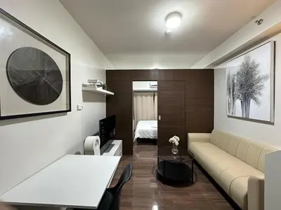 a living room with a couch and a table at King size bed at Air Residences Condo, Ayala Ave, Makati in Manila