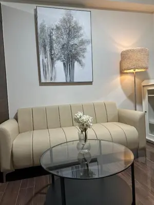 a living room with a couch and a glass table at King size bed at Air Residences Condo, Ayala Ave, Makati in Manila