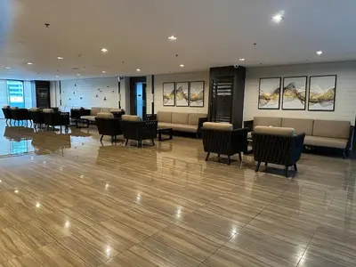 a lobby with chairs and tables in a building at King size bed at Air Residences Condo, Ayala Ave, Makati in Manila