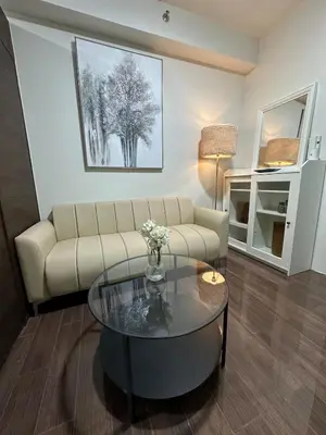 a living room with a couch and a glass table at King size bed at Air Residences Condo, Ayala Ave, Makati in Manila