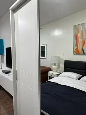 a bedroom with a bed and a mirror at Suite at Air Residences Condo, Ayala Ave Makati in Manila