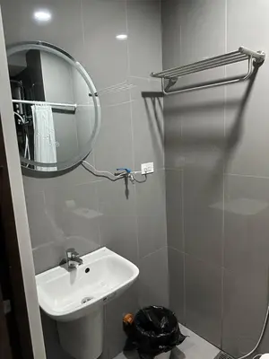 a bathroom with a sink and a mirror and a shower at Suite at Air Residences Condo, Ayala Ave Makati in Manila