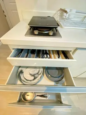 an open refrigerator drawer with a laptop on top at Azure Staycation PH in Manila