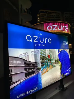 a tv screen with a sign for the zure lifestyle at Azure Staycation PH in Manila