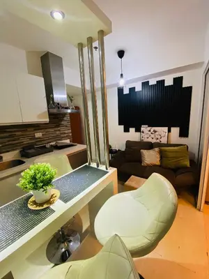 a living room with a couch and a table at Azure Staycation PH in Manila