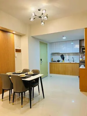 a dining room with a table and chairs and a kitchen at Kate's Haven Jazz Residences Makati, Manila in Manila