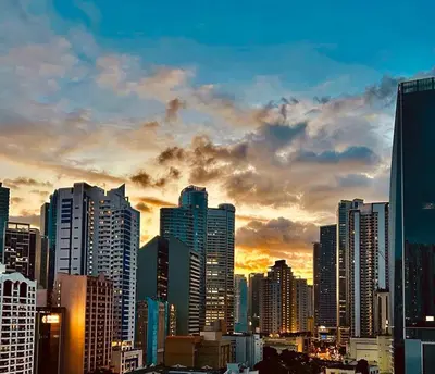 a view of a city skyline at sunset at Kate's Haven Jazz Residences Makati, Manila in Manila