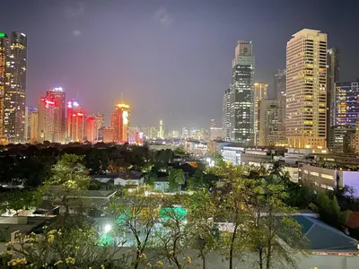 a city skyline at night with lit up buildings at Kate's Haven Jazz Residences Makati, Manila in Manila