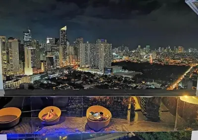 a view of a city skyline at night at Prime Location Walk to Nightlife! The Gramercy in Manila