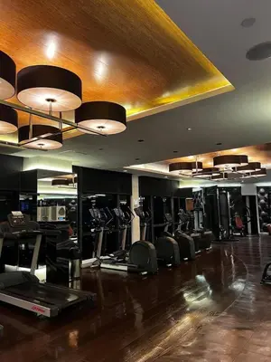 a gym with several rows of chairs and lights at Prime Location Walk to Nightlife! The Gramercy in Manila