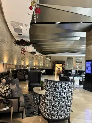a lobby with couches and tables in a building at Prime Location Walk to Nightlife! The Gramercy in Manila