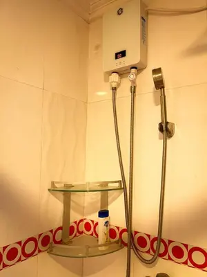 a shower in a bathroom with a glass shelf at Stunning 3BR with Sunset View near Dolomite Beach in Manila