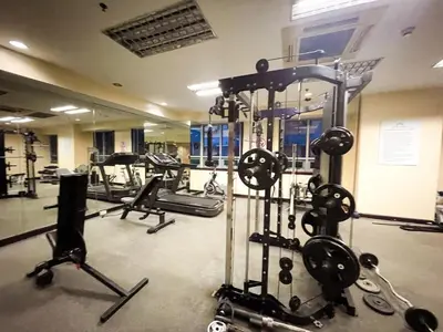 a gym with several exercise equipment in a room at Stunning 3BR with Sunset View near Dolomite Beach in Manila