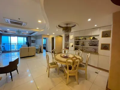 a dining room and living room with a table and chairs at Stunning 3BR with Sunset View near Dolomite Beach in Manila