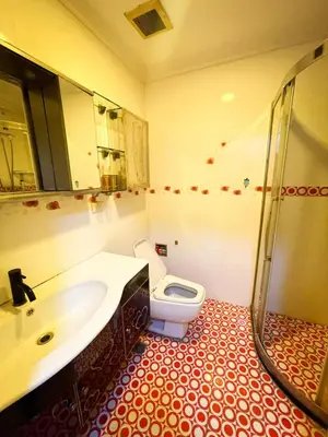 a bathroom with a sink and a toilet at Stunning 3BR with Sunset View near Dolomite Beach in Manila