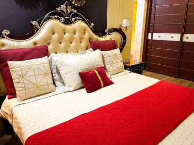 a large bed with red and white pillows on it at Stunning 3BR with Sunset View near Dolomite Beach in Manila