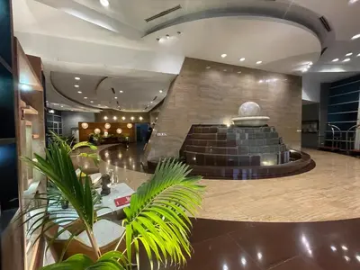 a lobby with a fountain in the middle of a building at Stunning 3BR with Sunset View near Dolomite Beach in Manila