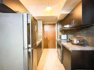 a kitchen with a stainless steel refrigerator in it at Stunning Sunset Retreat at Eton Bayview II 2pax in Manila