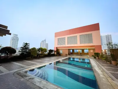 a large swimming pool in front of a building at Stunning Sunset Retreat at Eton Bayview II 2pax in Manila