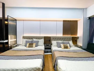 a room with three beds in a room at Stunning Sunset Retreat at Eton Bayview II 2pax in Manila