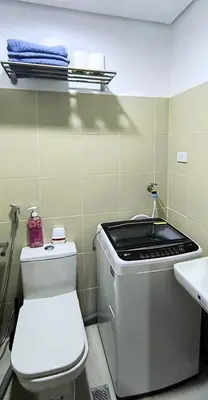 a small bathroom with a toilet and a sink at El Aris Lushly Inn in Manila