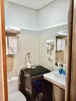 a small bathroom with a toilet and a sink at La Chicka Staycation in Coast Residences in Manila