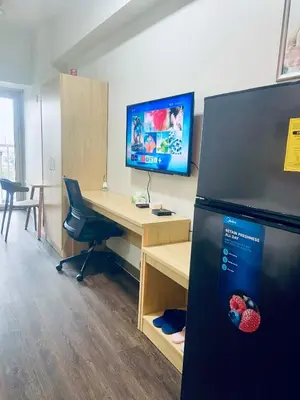 an office with a desk and a refrigerator at La Chicka Staycation in Coast Residences in Manila